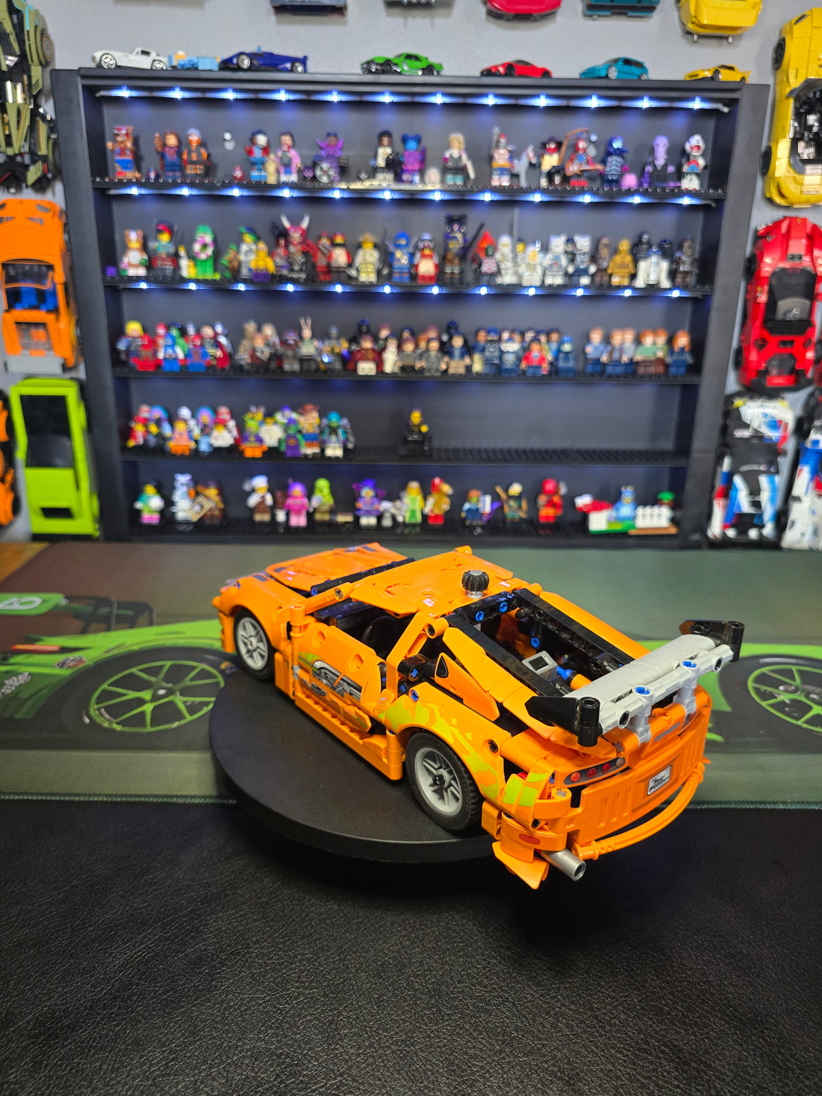 Rear three-quarter view of the orange Supra