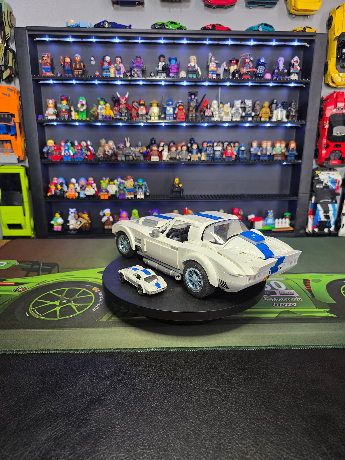 Side view of the large and small white Corvette