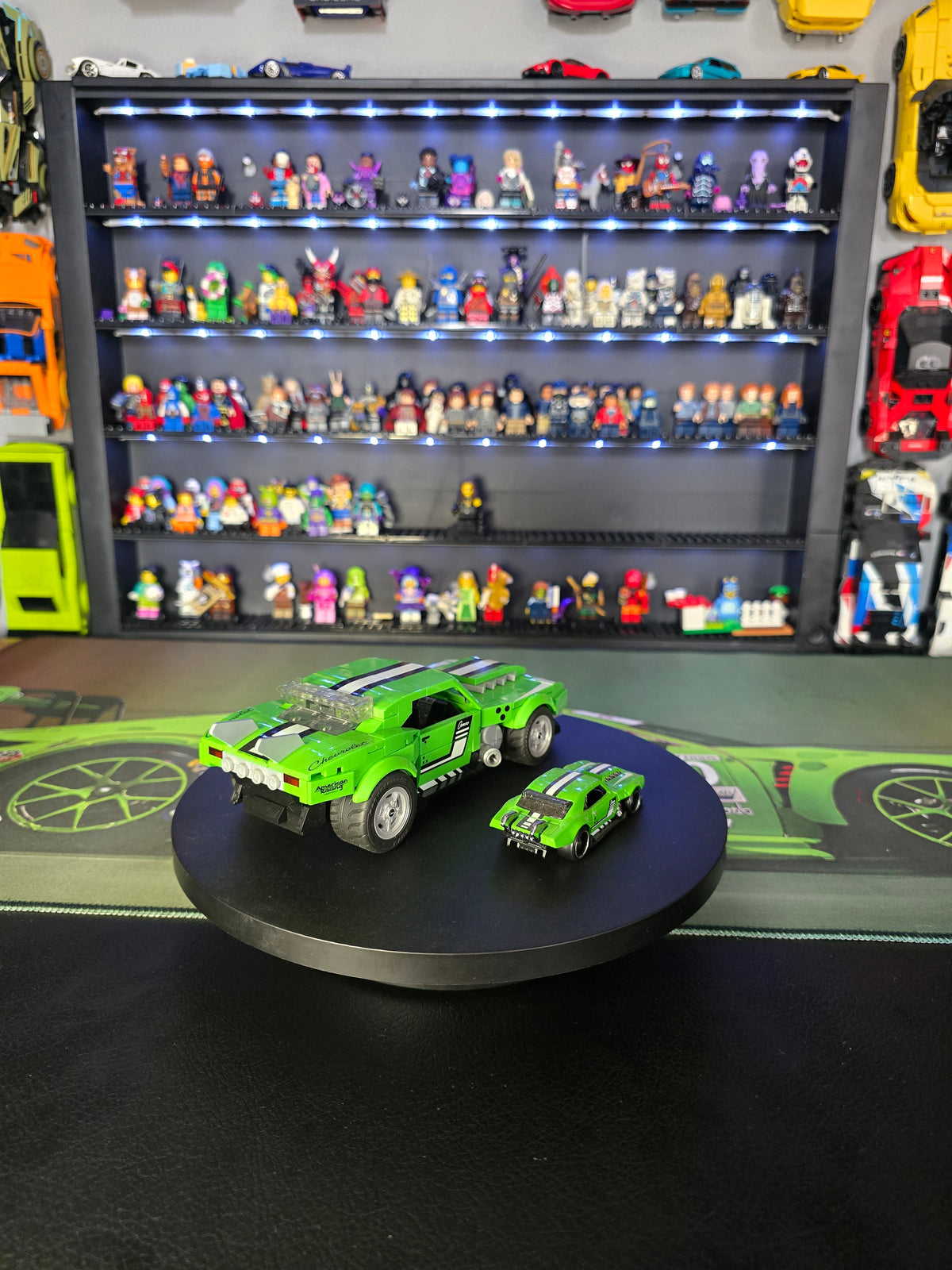 Side view of the large and small green Camaro