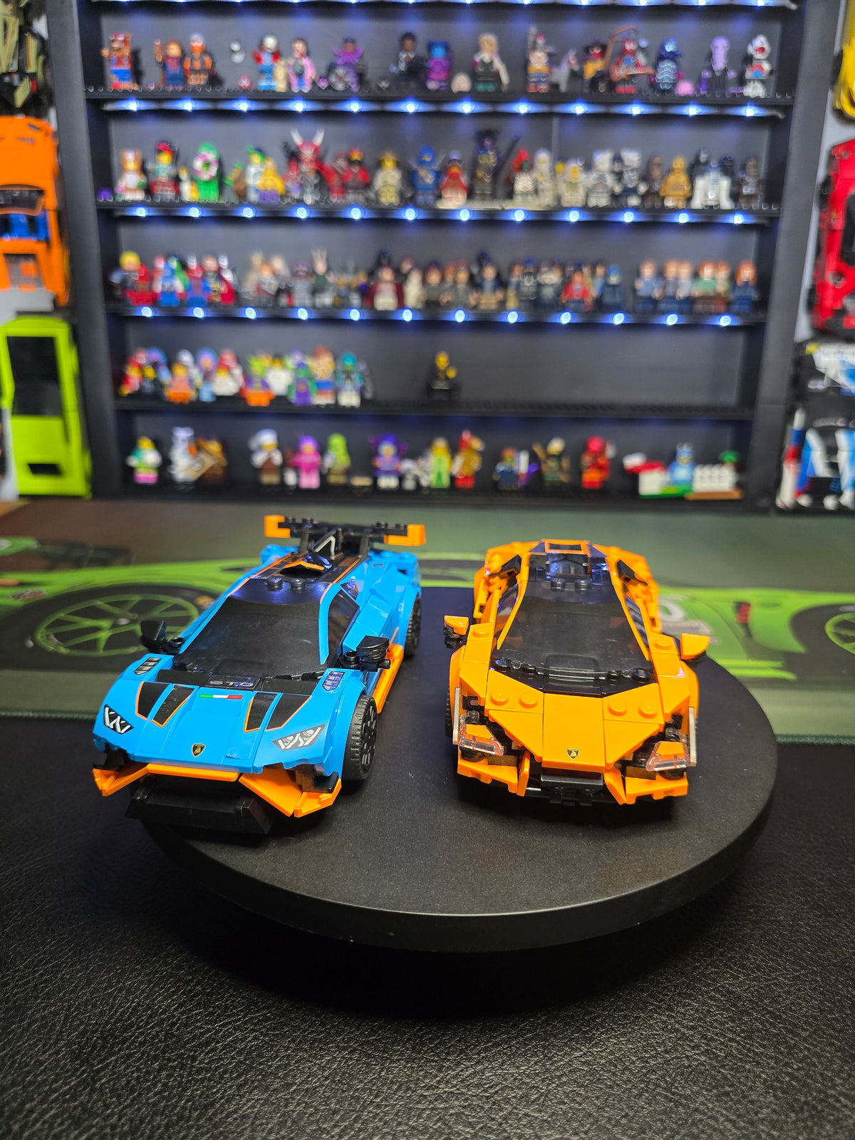Blue Huracán STO and orange Revuelto displayed together