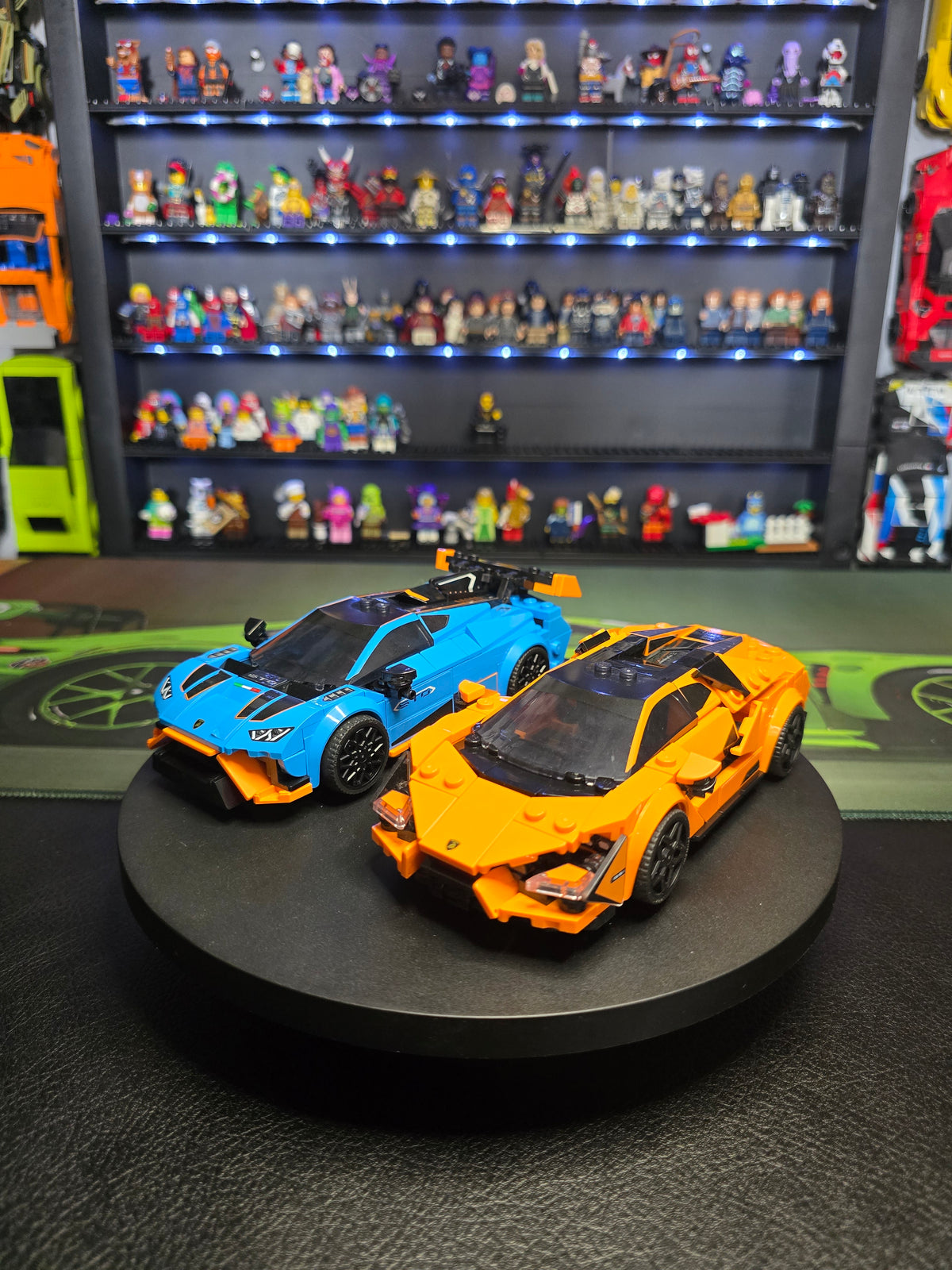 Side view of the orange Revuelto beside the blue Huracán STO