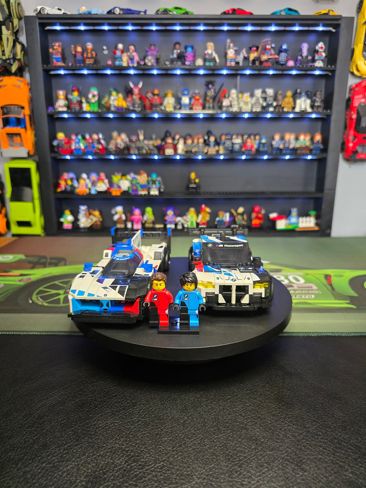 Both LEGO BMW race cars displayed with their driver figures