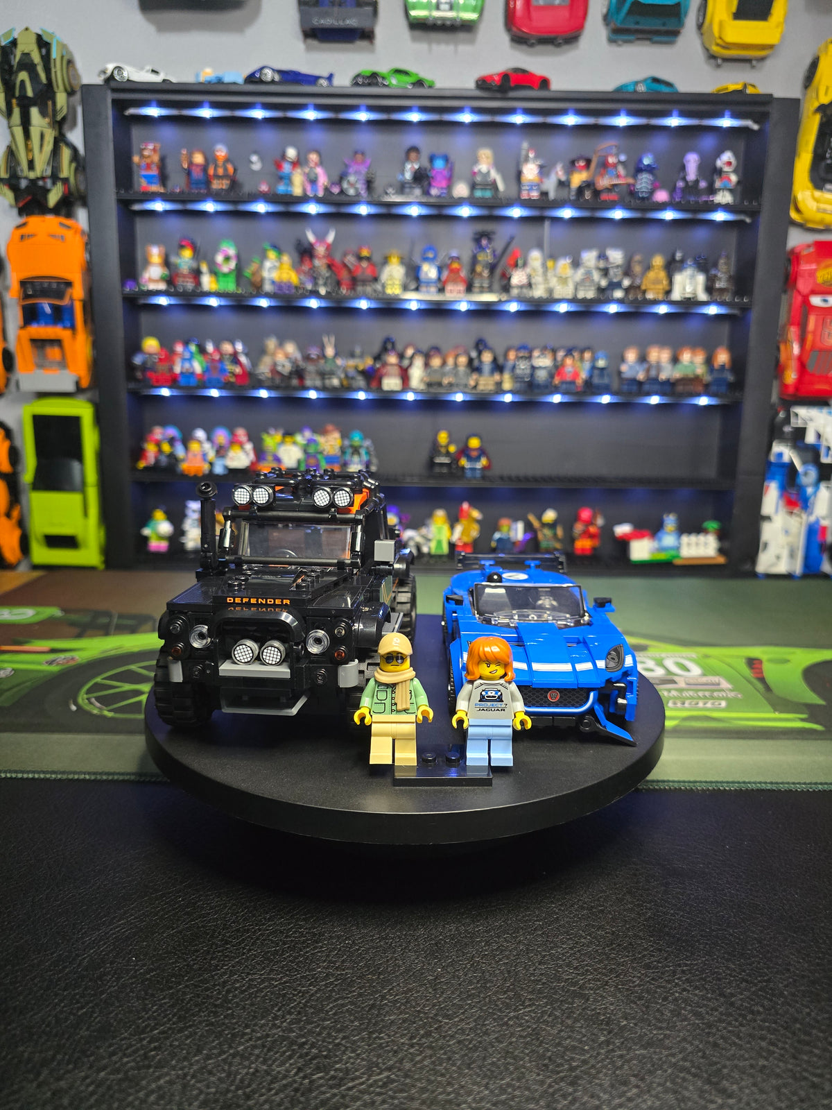 Jaguar Type 00 and Defender models displayed with both figures