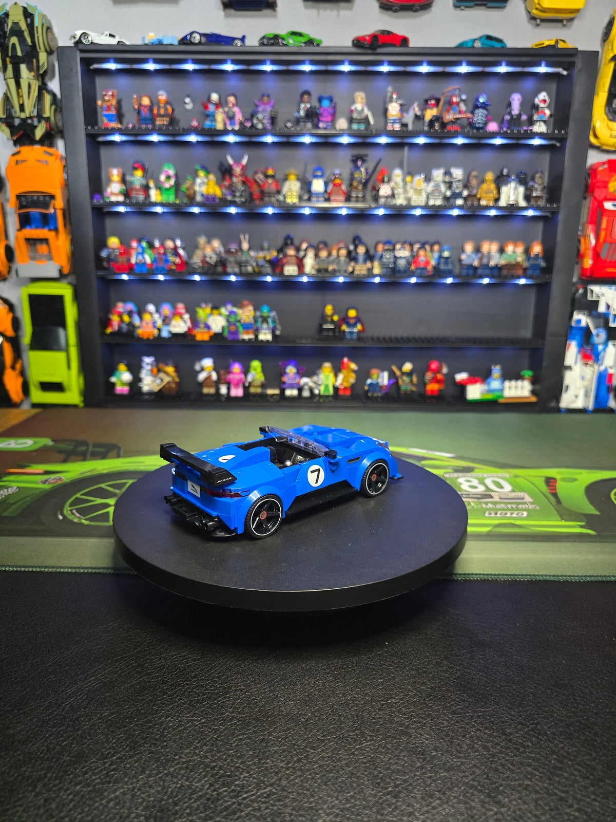 Blue LEGO Jaguar Type 00 on a display turntable