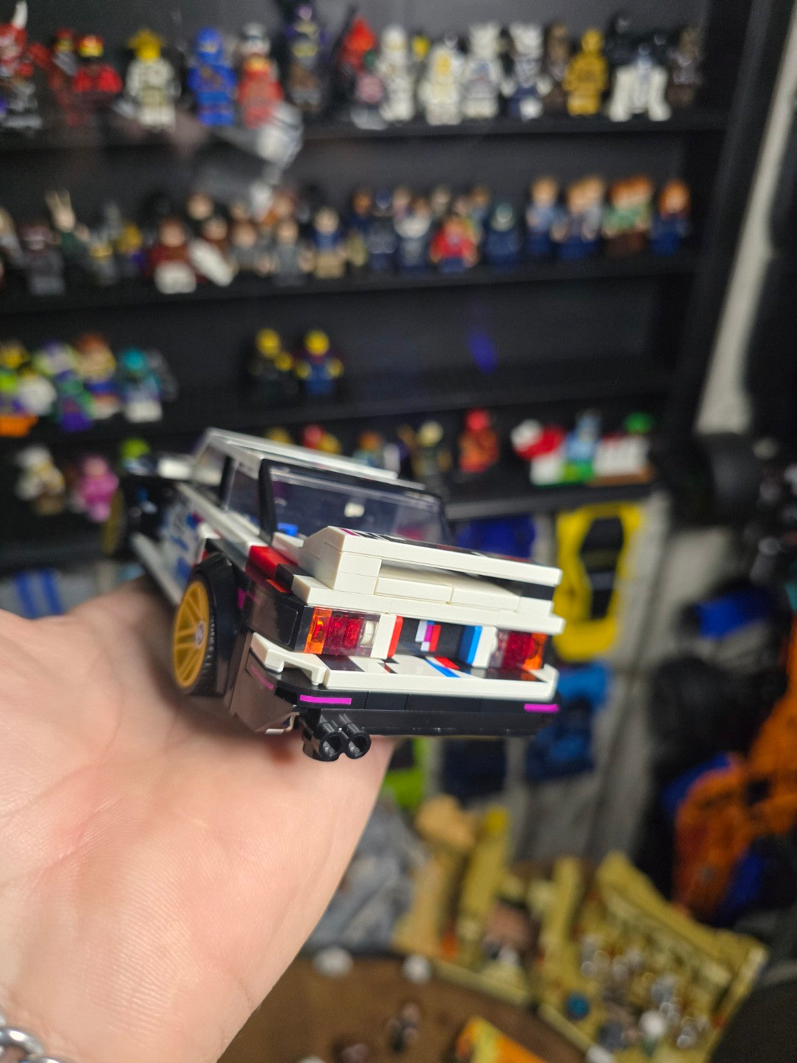 Built LEGO Speed Champions BMW M3 E30 held in hand, rear view
