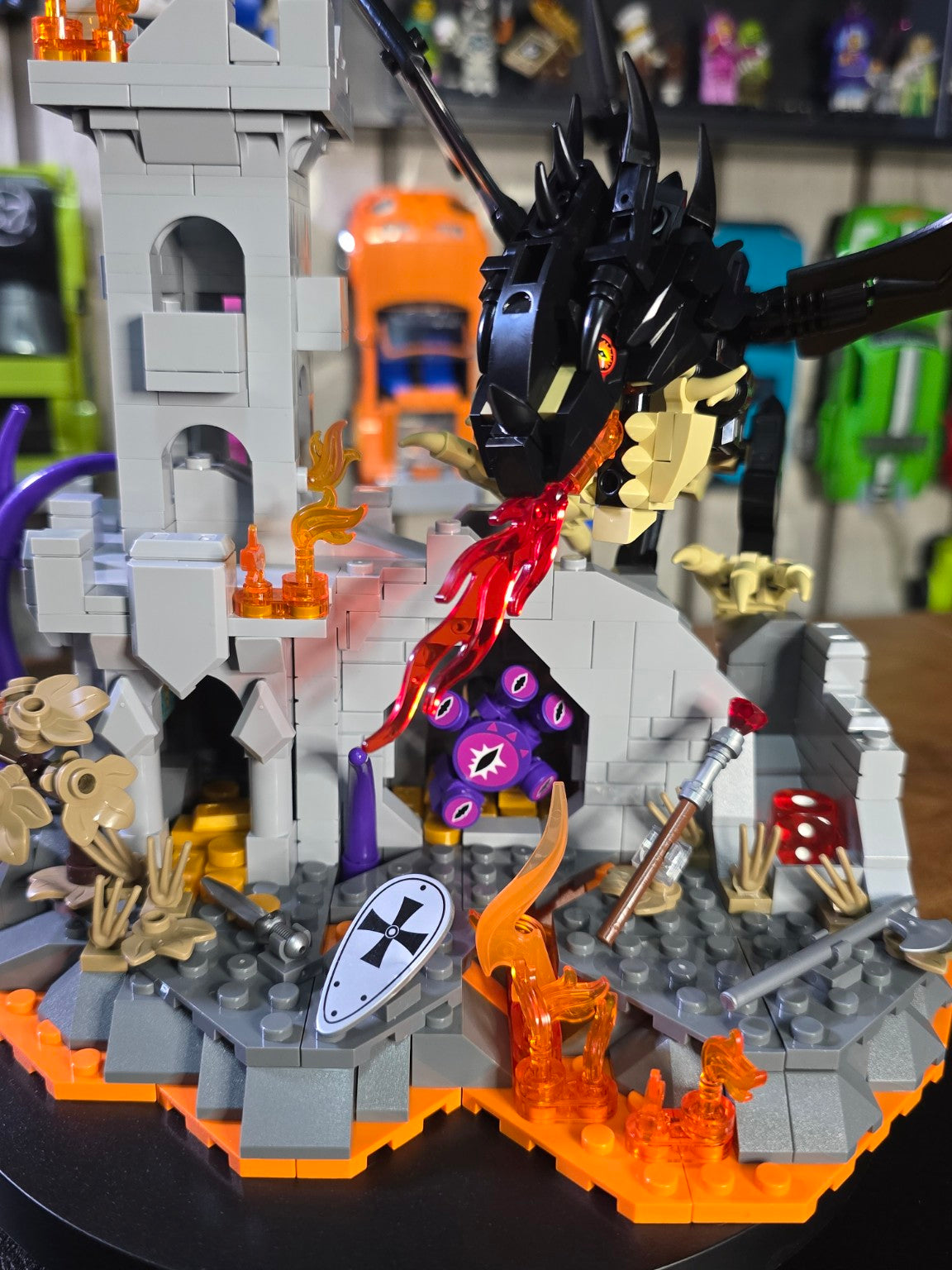 Close-up of the finished IAMBRICK Dragonfire Castle with black dragon and six-eyed creature in the wall