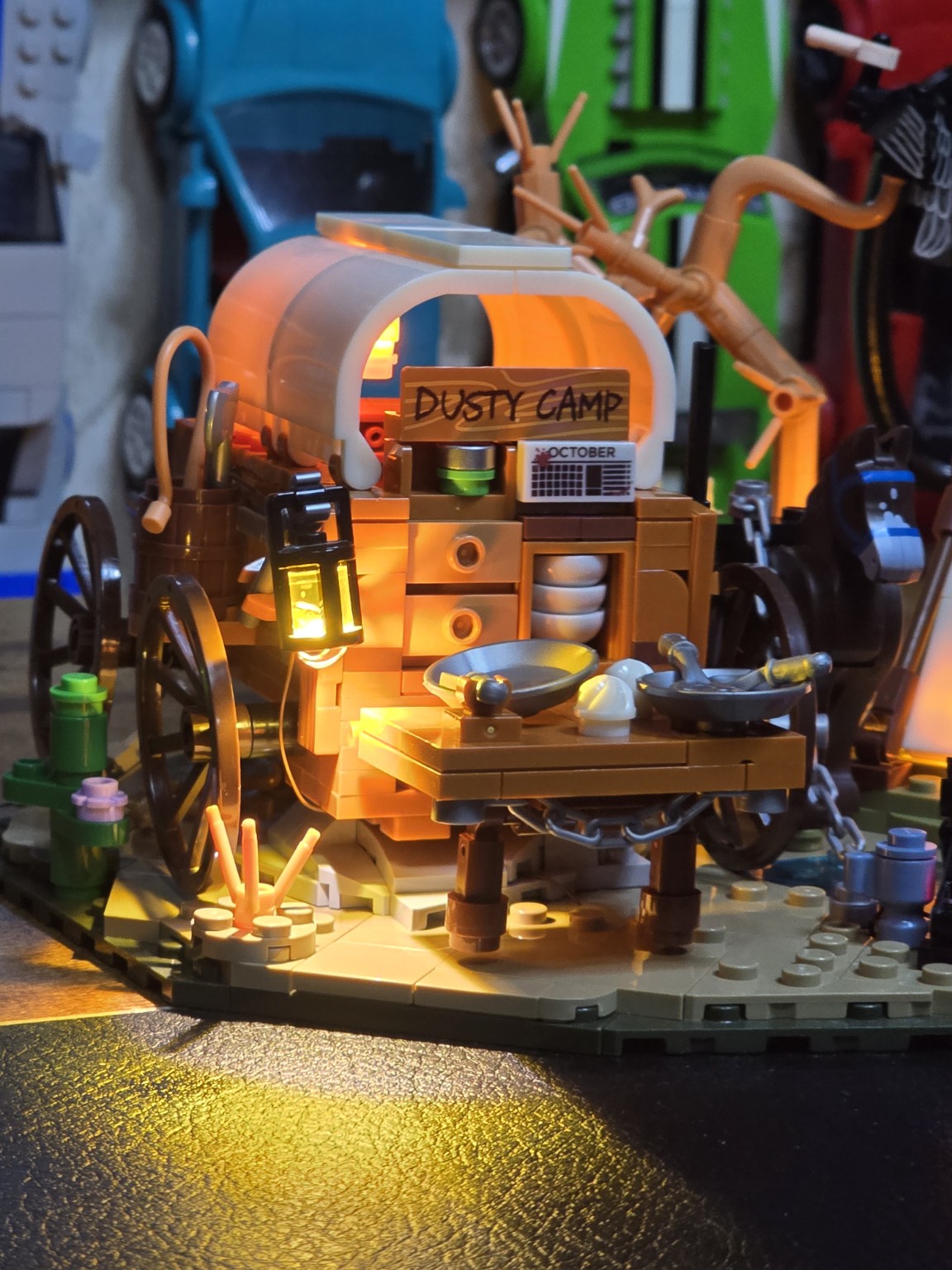 Close-up of the illuminated covered wagon and cooking area in the LumiBricks Cowboy Camp